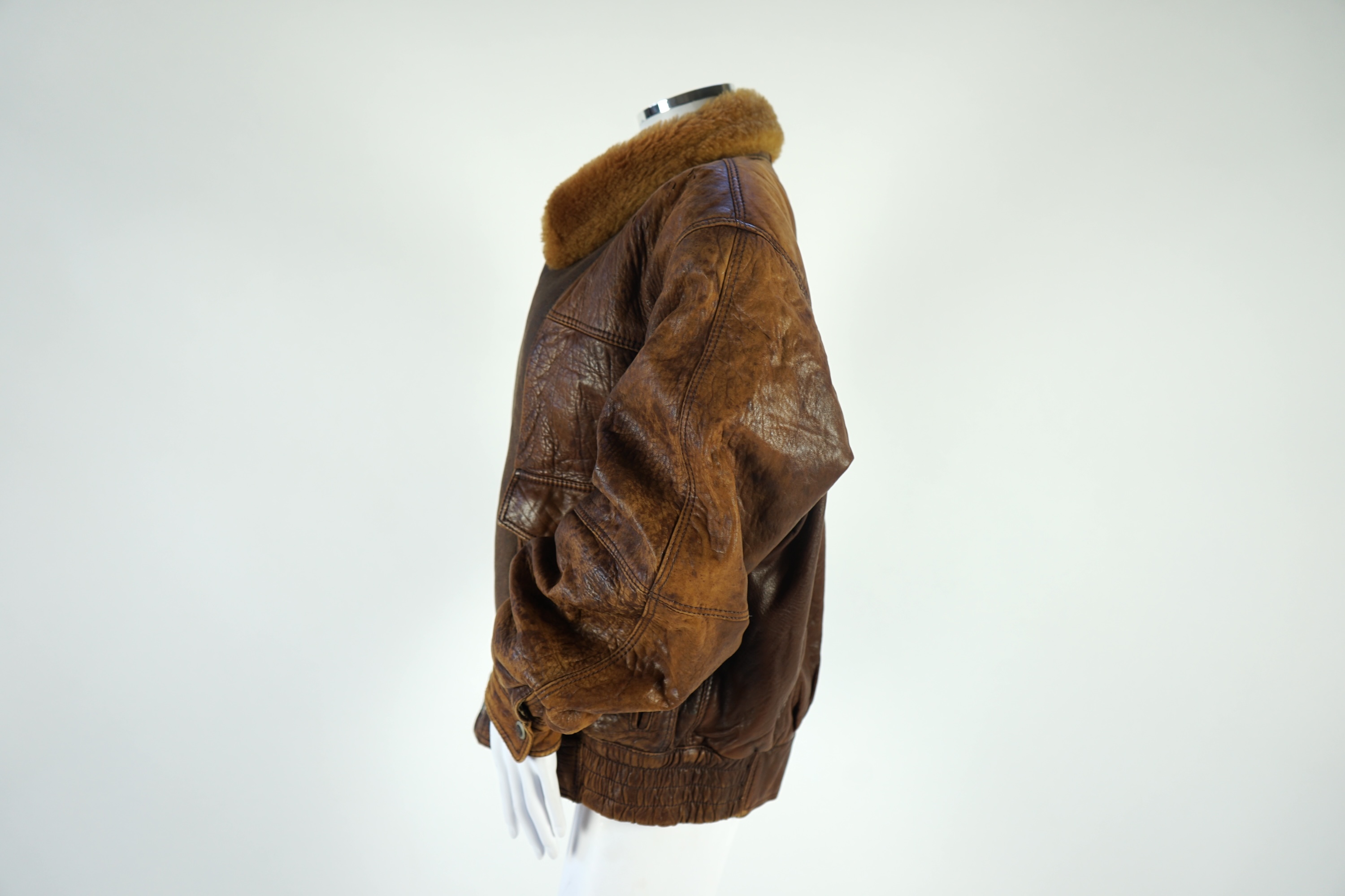 A gentleman's vintage brown leather bomber jacket made by The King, size unknown.